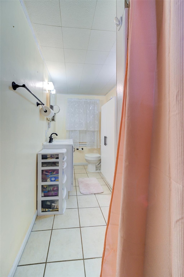 bathroom with vanity, toilet, and tile patterned flooring