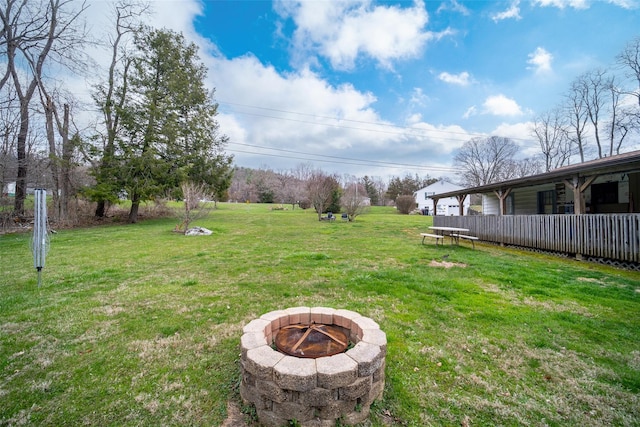 view of yard with a fire pit