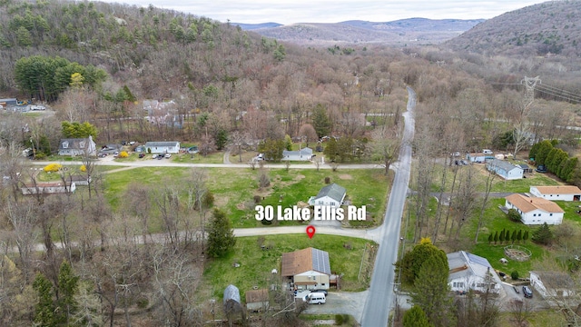 bird's eye view with a mountain view and a view of trees