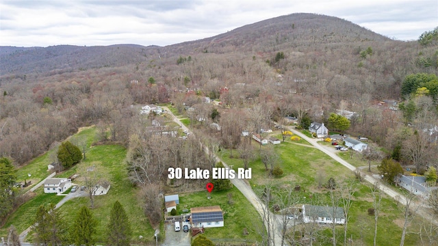 birds eye view of property featuring a mountain view and a view of trees