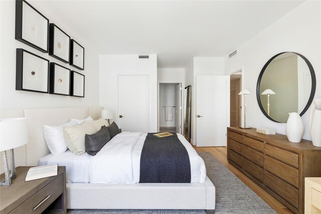 bedroom with wood finished floors and visible vents