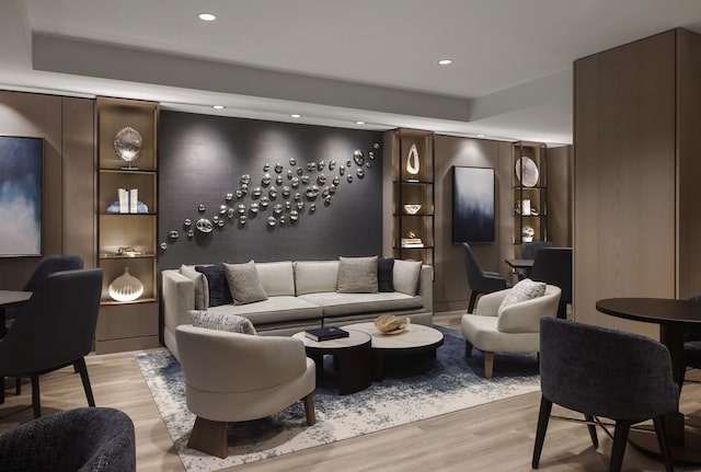 living area with recessed lighting and light wood-style floors
