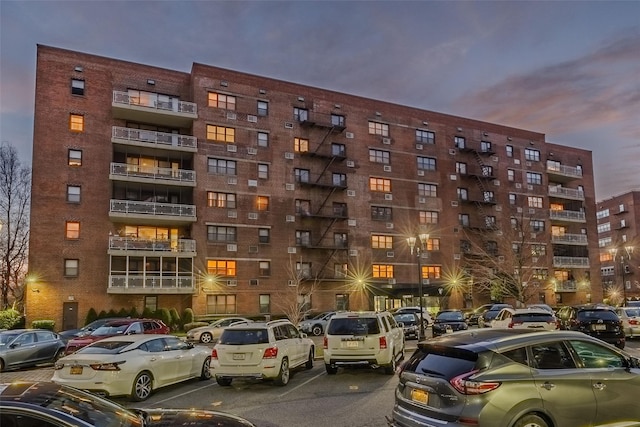 view of building exterior featuring uncovered parking