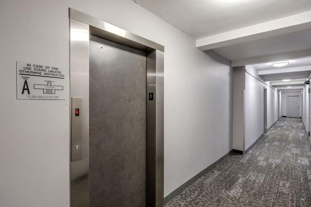88-25 155th Ave Unit 6L, Howard Beach, NY 11414 - corridor with elevator, beam ceiling, baseboards, and carpet floors