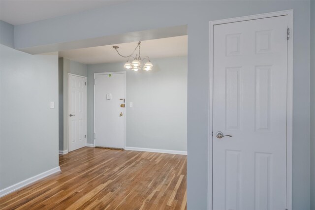 88-25 155th Ave Unit 6L, Howard Beach, NY 11414 - unfurnished room featuring wood finished floors, baseboards, and a chandelier