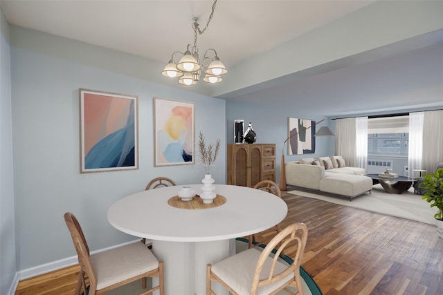 88-25 155th Ave Unit 6L, Howard Beach, NY 11414 - dining area with a chandelier, baseboards, and hardwood / wood-style flooring