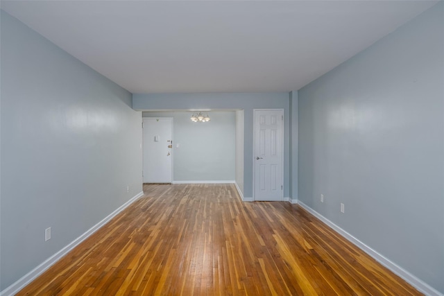 88-25 155th Ave Unit 6L, Howard Beach, NY 11414 - unfurnished room featuring baseboards, a notable chandelier, and hardwood / wood-style flooring