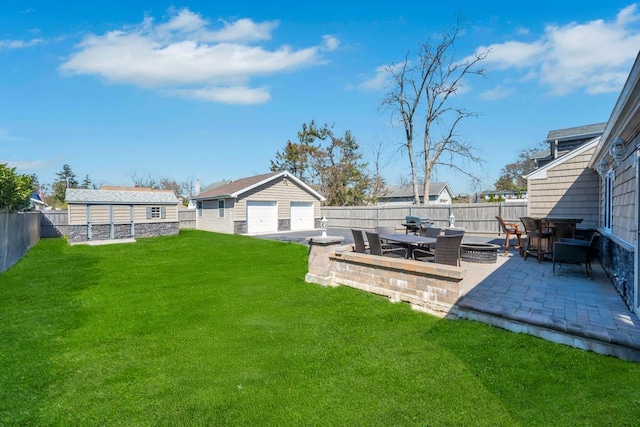 view of yard featuring an outdoor structure, a garage, a patio area, and a fenced backyard