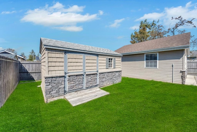 view of outbuilding featuring a fenced backyard and an outbuilding