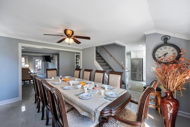 dining space featuring stairs, ceiling fan, ornamental molding, and baseboards