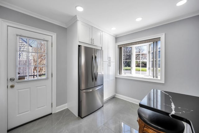 kitchen with baseboards, freestanding refrigerator, and a healthy amount of sunlight