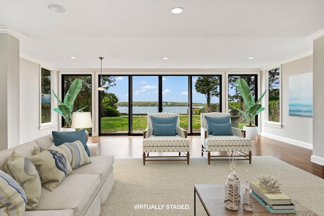 145 Asharoken Ave, Northport, NY 11768 - living room with wood finished floors, baseboards, a water view, ornamental molding, and recessed lighting