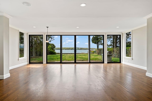 145 Asharoken Ave, Northport, NY 11768 - unfurnished living room featuring wood finished floors, baseboards, a water view, ornamental molding, and recessed lighting