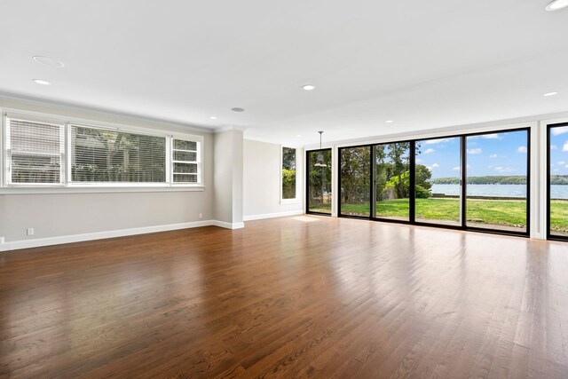 145 Asharoken Ave, Northport, NY 11768 - unfurnished living room featuring baseboards, crown molding, wood finished floors, and recessed lighting