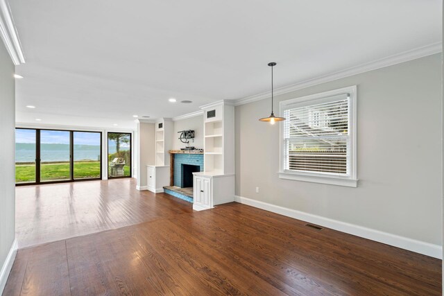 145 Asharoken Ave, Northport, NY 11768 - unfurnished living room with baseboards, ornamental molding, a brick fireplace, and dark wood finished floors