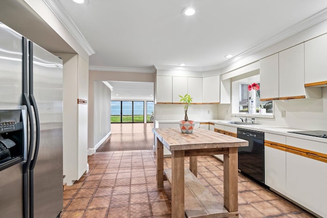 145 Asharoken Ave, Northport, NY 11768 - kitchen featuring light countertops, crown molding, recessed lighting, white cabinets, and black appliances