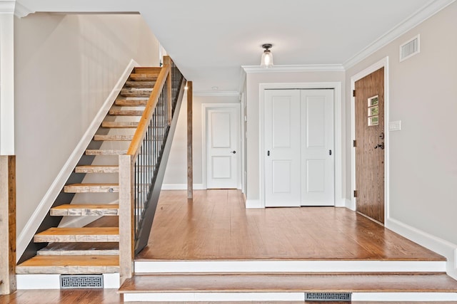 145 Asharoken Ave, Northport, NY 11768 - staircase featuring visible vents, ornamental molding, and wood finished floors