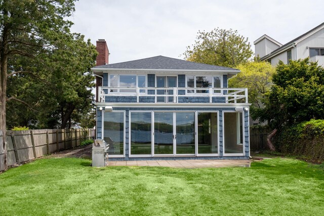 145 Asharoken Ave, Northport, NY 11768 - back of property featuring a balcony, a yard, a chimney, and fence private yard