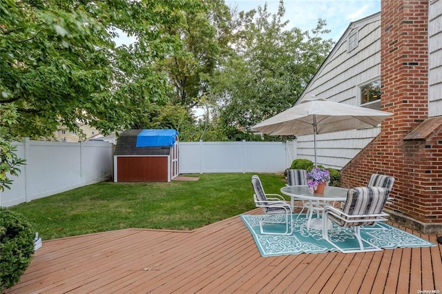 2872 Rosebud Ave, Merrick, NY 11566 - wooden terrace with a storage unit, a yard, an outdoor structure, and a fenced backyard