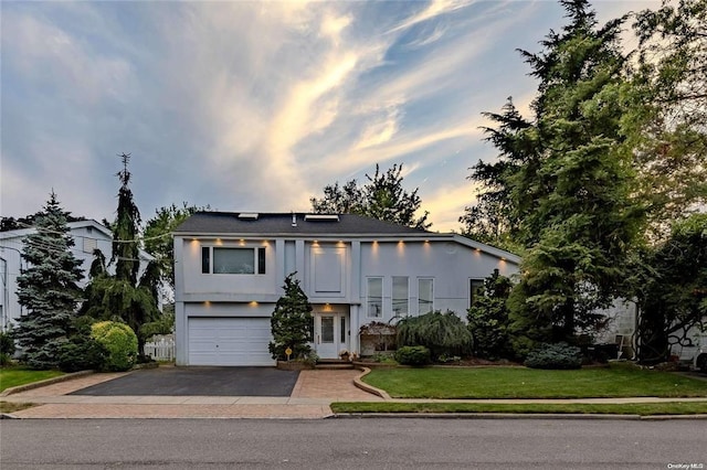 2872 Rosebud Ave, Merrick, NY 11566 - view of front of property with aphalt driveway, an attached garage, a front lawn, and stucco siding