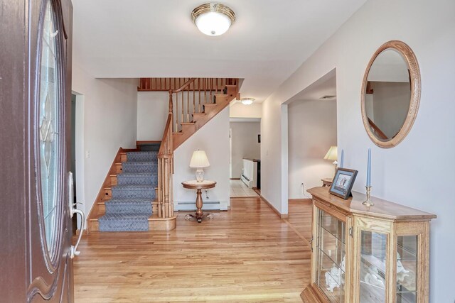 1 Mohawk Ct, Stony Point, NY 10980 - entrance foyer featuring a baseboard heating unit, baseboards, stairs, and light wood-type flooring