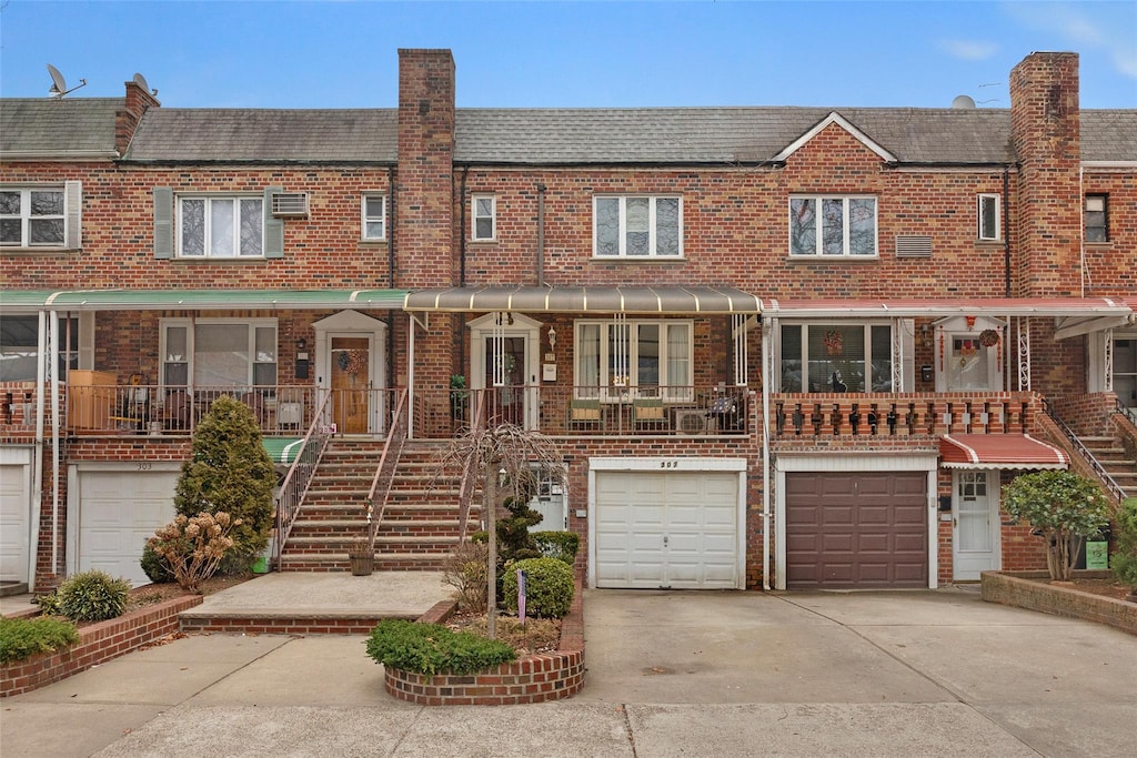 307 Bay 11th St, Brooklyn, NY 11228 - multi unit property with an attached garage, brick siding, a chimney, and driveway