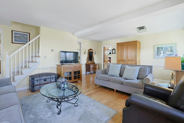 24 Burnsdale Ave, Valhalla, NY 10595 - living room featuring stairway, light wood-style flooring, beam ceiling, and baseboards