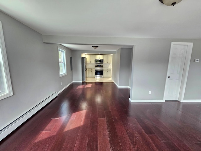 unfurnished living room featuring dark wood-type flooring, baseboards, and a baseboard radiator