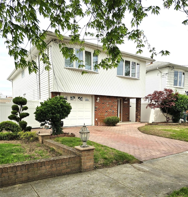 159-42 81st St, Howard Beach, NY 11414 - view of front of home with fence, an attached garage, decorative driveway, and brick siding