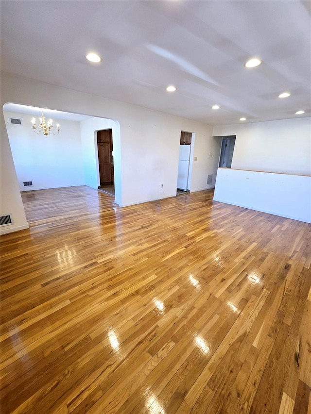 159-42 81st St, Howard Beach, NY 11414 - empty room featuring light wood-style floors, recessed lighting, visible vents, and an inviting chandelier