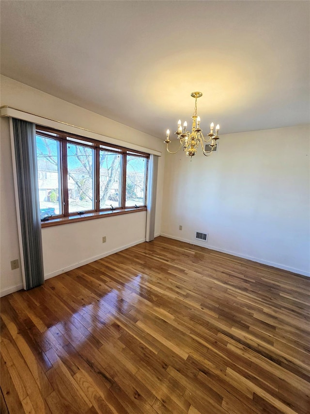 159-42 81st St, Howard Beach, NY 11414 - empty room with baseboards, dark wood-type flooring, a chandelier, and visible vents