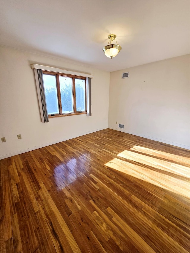 159-42 81st St, Howard Beach, NY 11414 - empty room with visible vents and wood finished floors