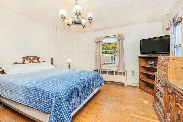 3476 Bruner Ave, Bronx, NY 10469 - bedroom featuring radiator, wood finished floors, and a notable chandelier