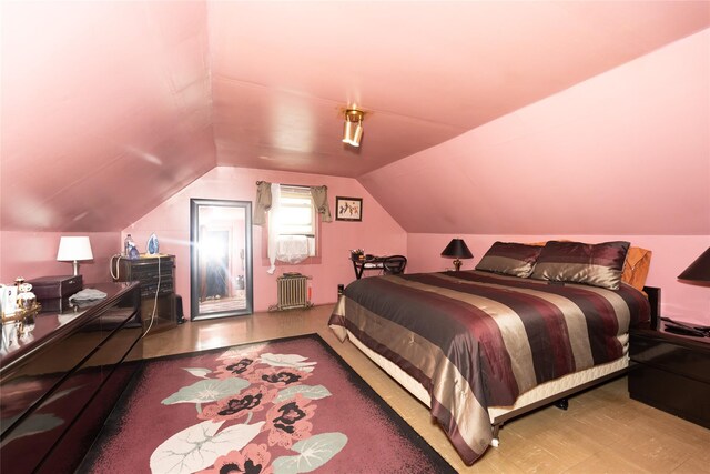 3476 Bruner Ave, Bronx, NY 10469 - bedroom featuring radiator heating unit, wood finished floors, and lofted ceiling