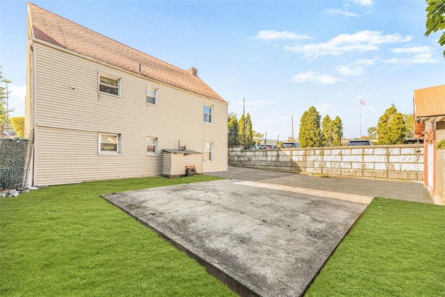 3476 Bruner Ave, Bronx, NY 10469 - rear view of property featuring a patio, a fenced backyard, and a yard