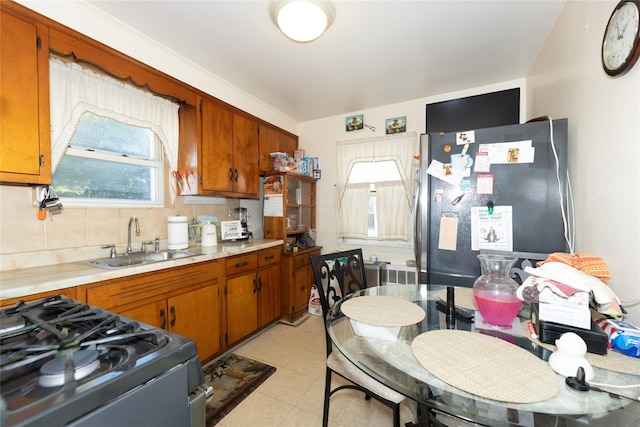 3476 Bruner Ave, Bronx, NY 10469 - kitchen with a sink, appliances with stainless steel finishes, brown cabinets, and light countertops