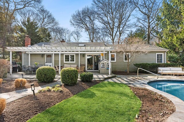 10 Rolling Hill Rd, Hampton Bays, NY 11946 - rear view of house with an outdoor living space, an outdoor pool, a pergola, and a patio
