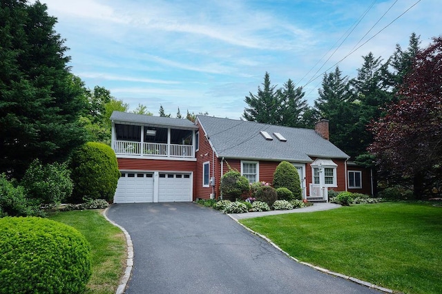 28 Rose Ave, Great Neck, NY 11021 - view of front facade featuring driveway, a chimney, a front yard, and a garage