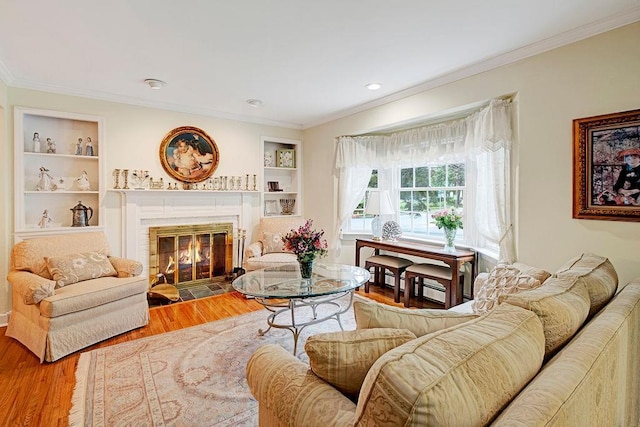 28 Rose Ave, Great Neck, NY 11021 - living area featuring ornamental molding, wood finished floors, a fireplace with flush hearth, and built in shelves
