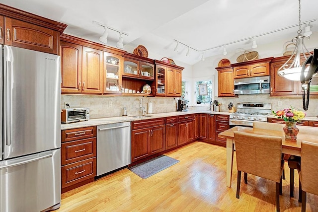 28 Rose Ave, Great Neck, NY 11021 - kitchen with appliances with stainless steel finishes, track lighting, a sink, light wood-style floors, and light countertops