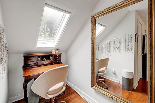 28 Rose Ave, Great Neck, NY 11021 - home office featuring a skylight, vaulted ceiling, wood finished floors, and baseboards