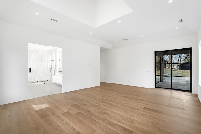 spare room with light wood-style flooring, visible vents, and recessed lighting