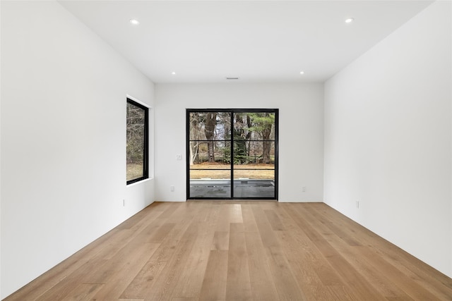 spare room featuring recessed lighting and light wood-style flooring