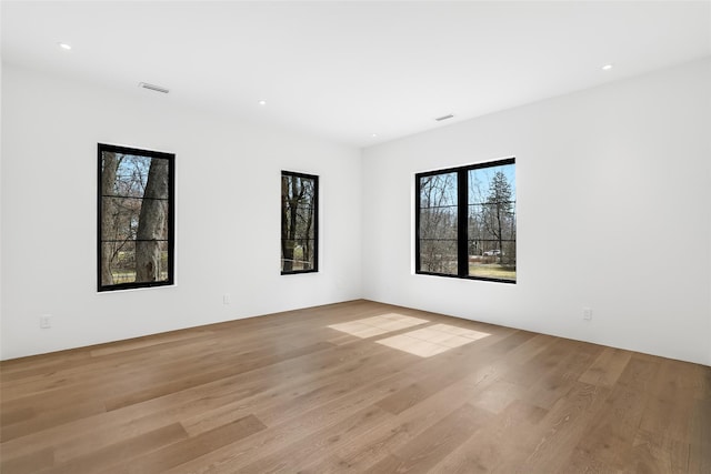 spare room with recessed lighting, visible vents, and light wood-style flooring