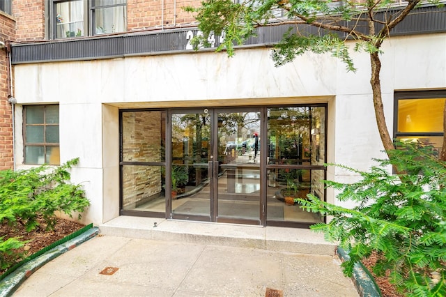 doorway to property with brick siding and french doors
