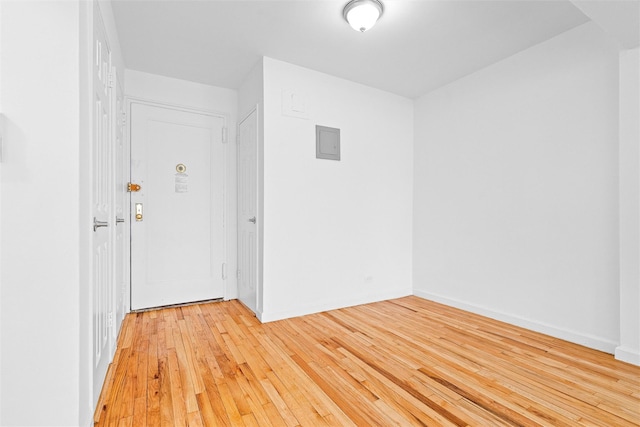 empty room with baseboards and light wood-style flooring