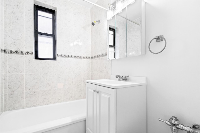bathroom featuring a wealth of natural light, shower / bathtub combination, and vanity