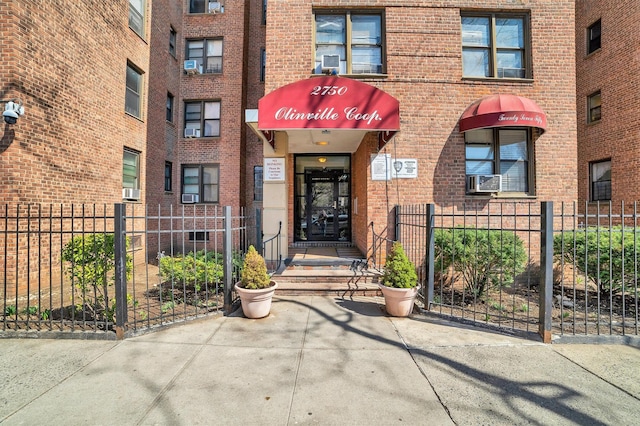 2750 Olinville Ave Unit 1K, Bronx, NY 10467 - property entrance with brick siding and fence
