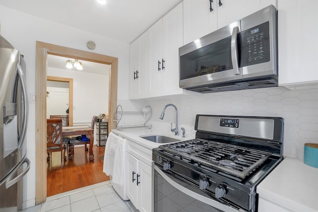 2750 Olinville Ave Unit 1K, Bronx, NY 10467 - kitchen with stainless steel appliances, light countertops, a sink, and decorative backsplash