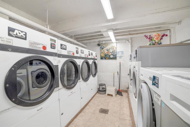 2750 Olinville Ave Unit 1K, Bronx, NY 10467 - shared laundry area with washer and clothes dryer, concrete block wall, stacked washer / dryer, and light tile patterned flooring